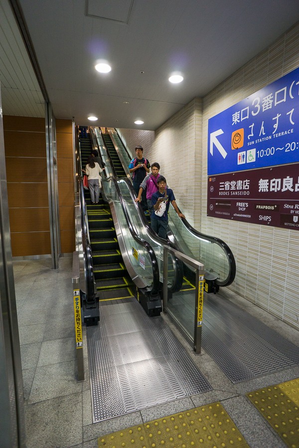 This looks like a retrofit of an existing staircase. Why else would the escalator "jog" like that?